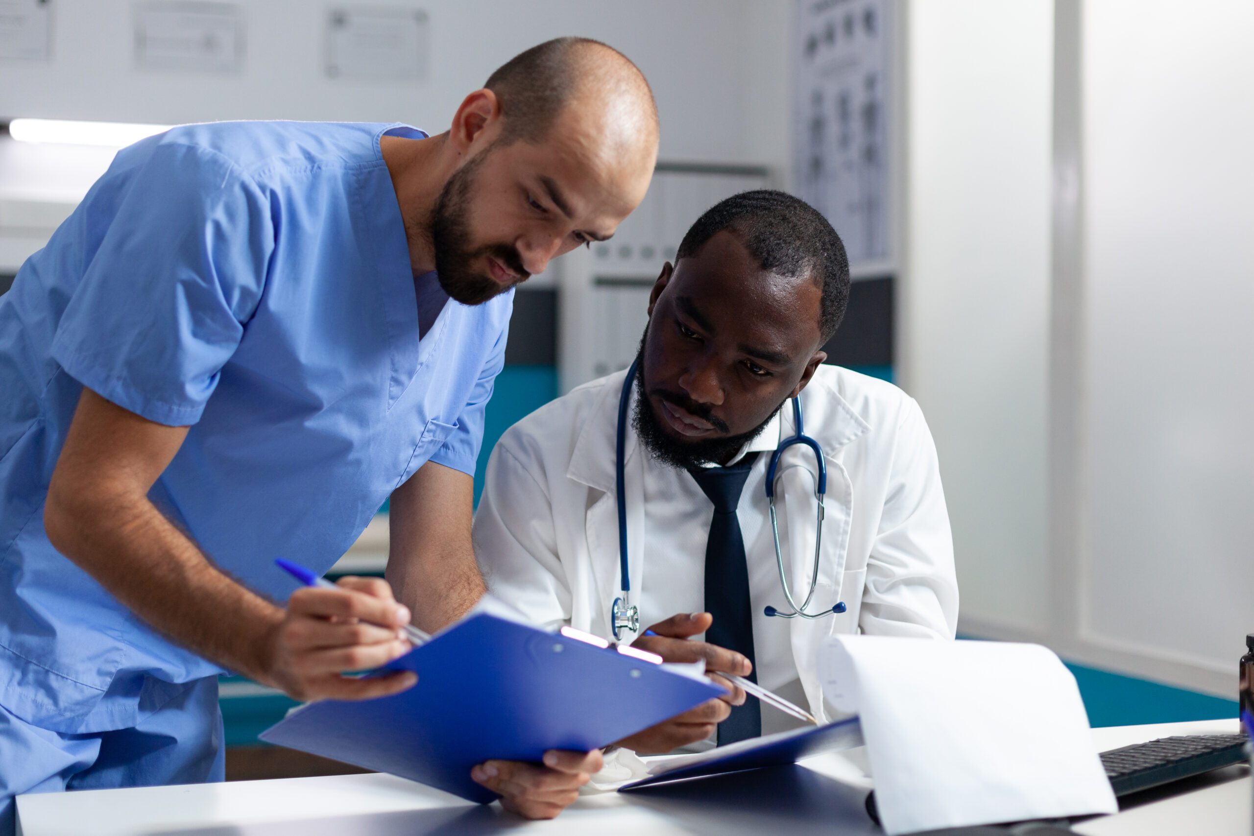 african american doctor discussing healthcare treatment with man nurse