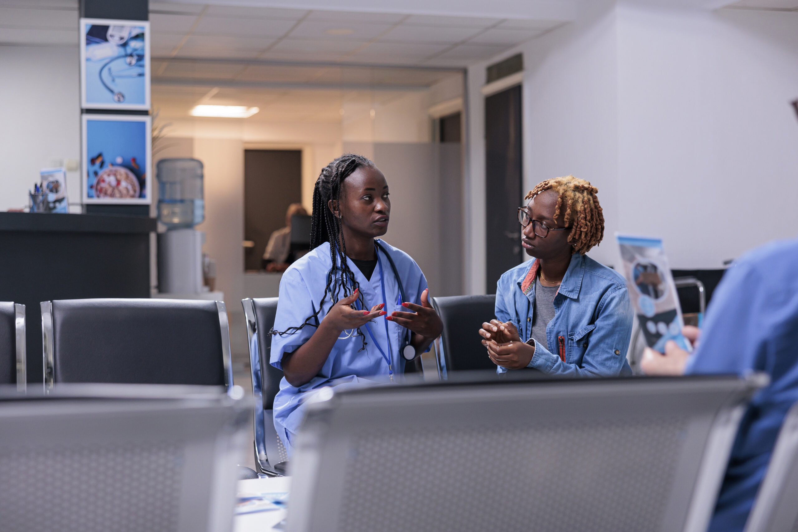 medical assistant consulting woman at clinic