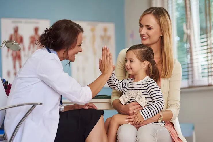 imgi 3 doctor giving high five smiling girl sitting her mother 039 s lap medical appointme